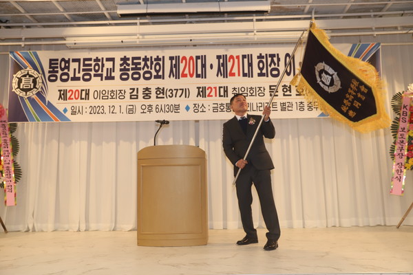 김충현 이임회장이 문현호 취임회장에게 총동창회기를 전달, 문 취임회장은 헌신과 단결을 다짐했다.